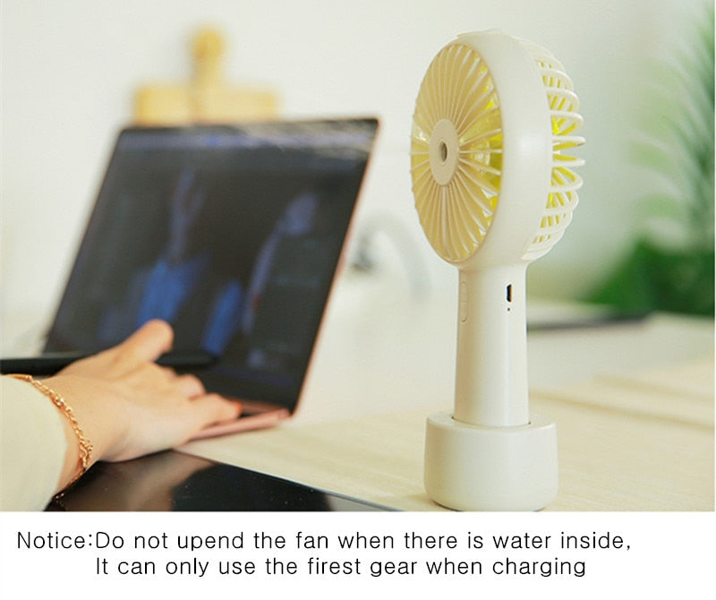 USB Rechargeable Handheld Mini cooling fan with water spray mist.