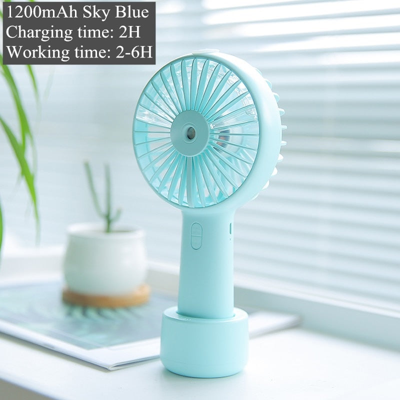 USB Rechargeable Handheld Mini cooling fan with water spray mist.