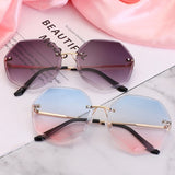 Women's rimless Gradient designer sunglasses.