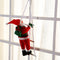 Christmas Decoration Of Santa Claus Climbing on A Rope Ladder.